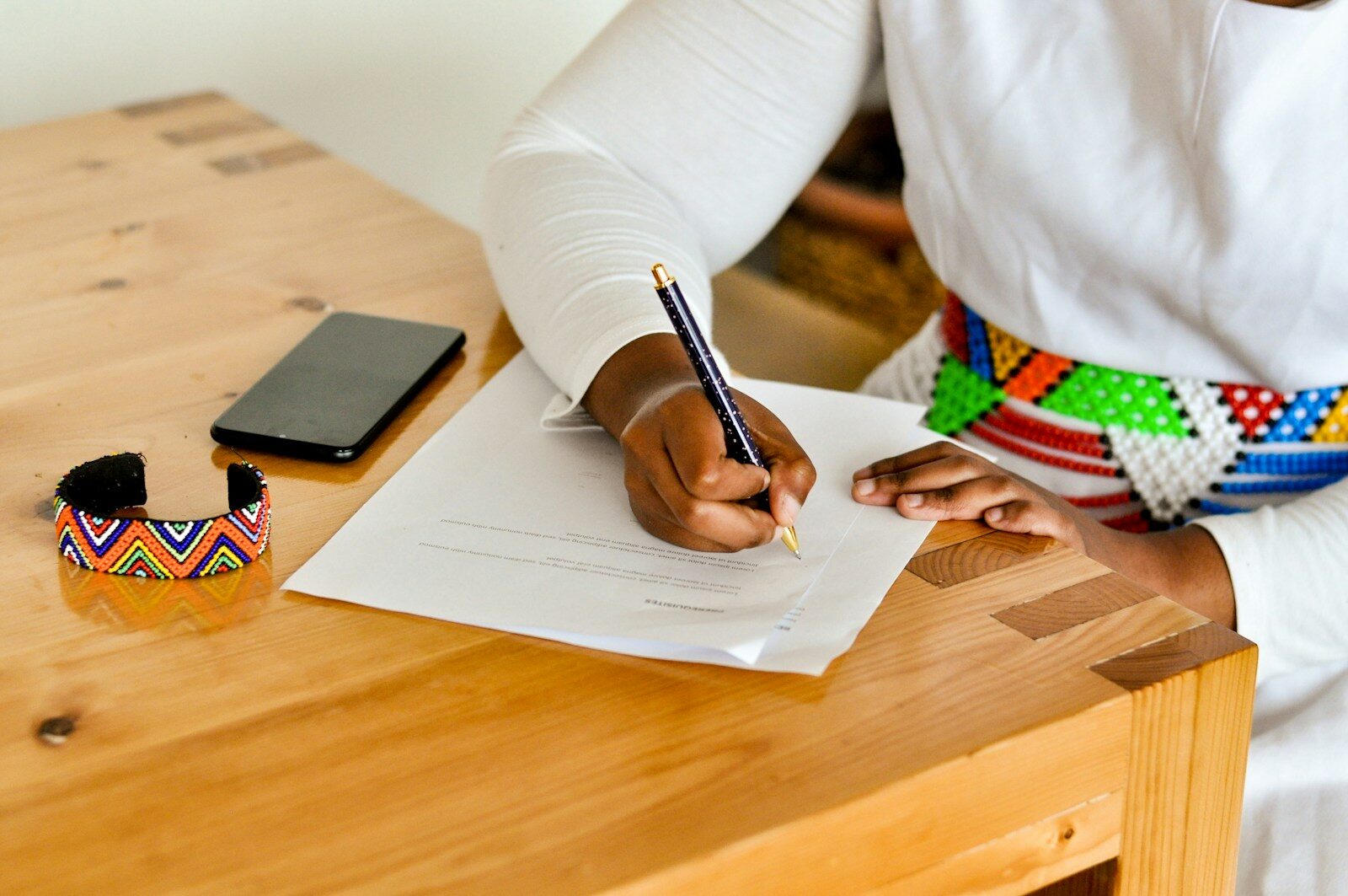 a person writing on a piece of paper